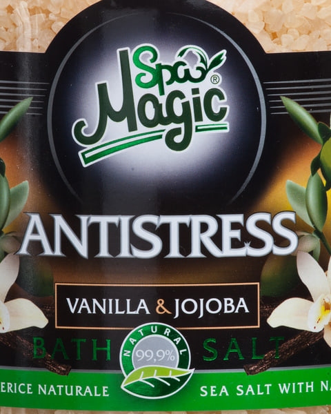 Eticheta Antistress în prim-plan, cu floare de vanilie și ramuri de jojoba