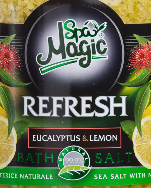 Close-up of the Refresh label: eucalyptus in red blossom and whole lemons either side of the name